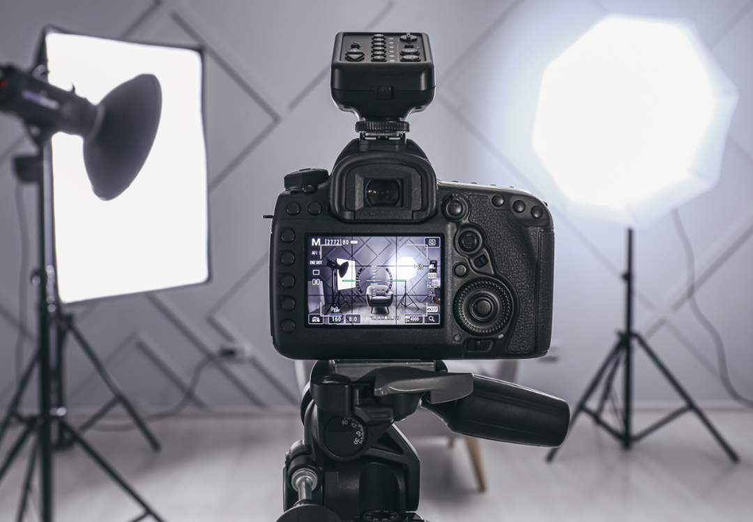 Photography studio with two lights on and a camera on a tripod